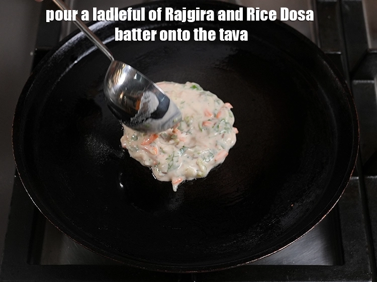 Step 14 – <p>Pour a ladleful of <strong>Rajgira and Rice Dosa</strong> batter onto the tava.</p>