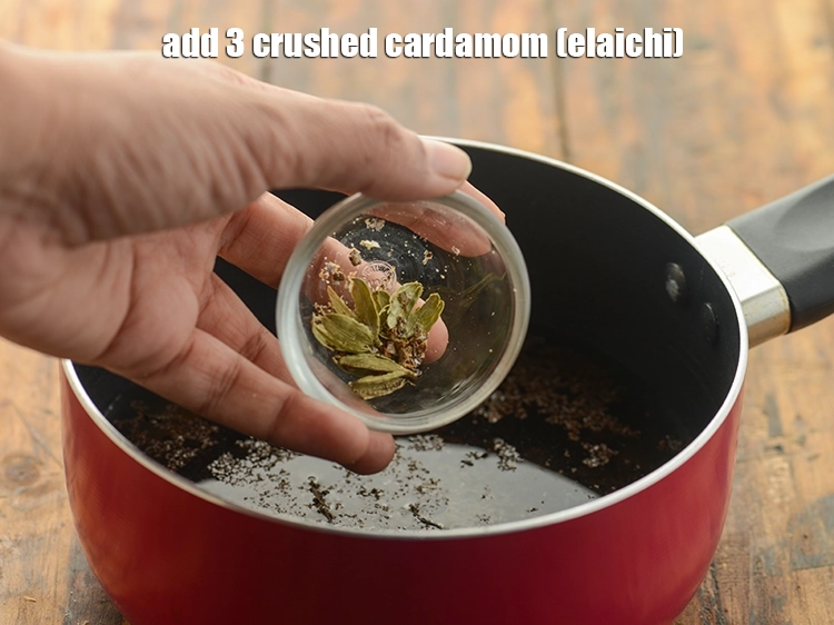 Step 5 – <p>Add cardamom. We have coarsely crushed the elaichi in a mortar pestle and kept the …