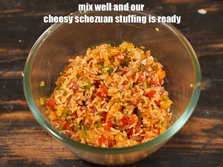 Step 10 – <p>Mix well and our cheesy schezuan stuffing is ready.</p>