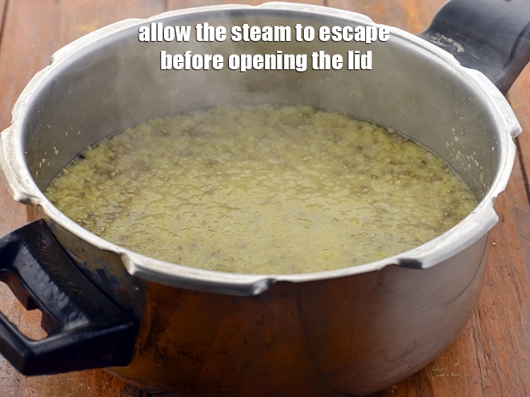 Step 28 – <p>Allow the steam to escape before opening the lid. Open the pressure cooker.</p>