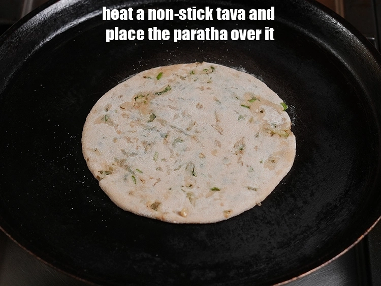 Step 25 – <p>Heat a non-stick tava and place the paratha over it.</p>