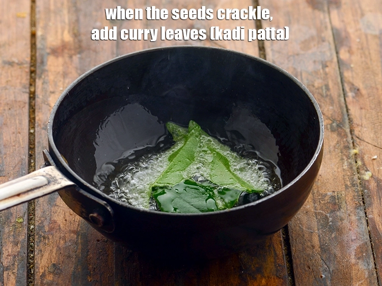 Step 14 – <p>When the seeds crackle, add <span style="background-color:rgb(255,255,255);color:rgb(0,0,0);">5 to 6 </span><a href="https://www.tarladalal.com/glossary-curry-leaves-kadi-patta-kadipatta-388i"><u>curry leaves (kadi patta)</u></a>.&nbsp;</p>
