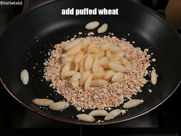 Step 13 – <p>Add ¾ cup <a href="https://www.tarladalal.com/glossary-puffed-wheat-wheat-kurmura-wheat-mamra-194i">puffed wheat</a>.</p>