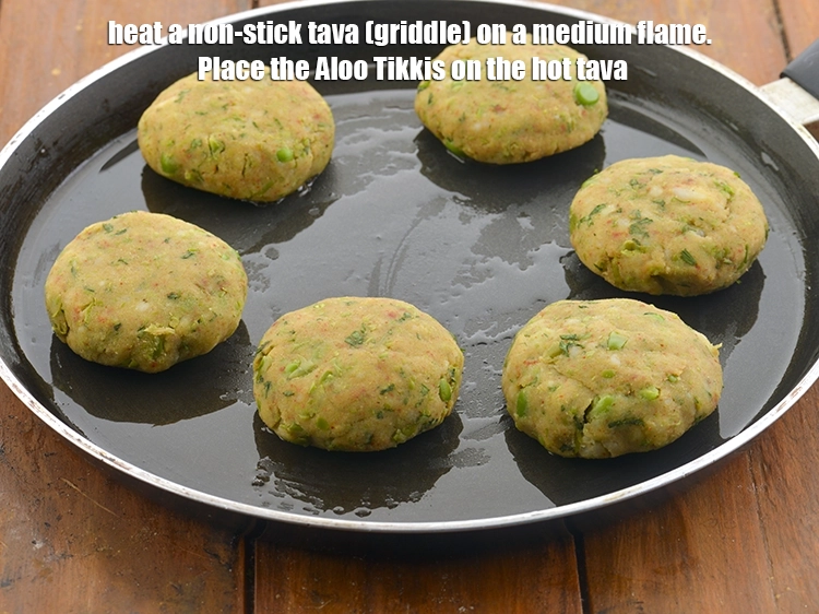 Step 14 – <p>Heat a non-stick tava (griddle) on a medium flame. Place the&nbsp;<strong>Aloo Tikkis</strong>&nbsp;on the hot tava.</p>