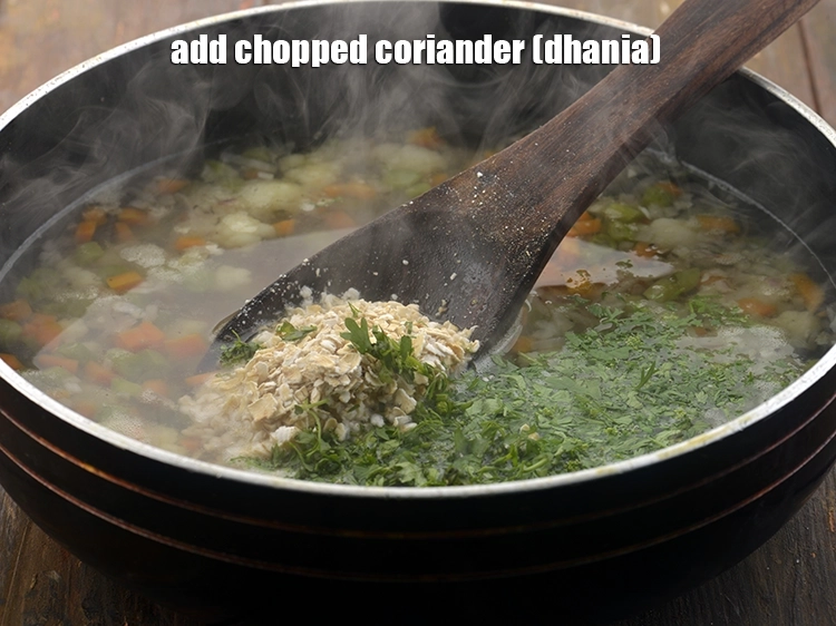 Step 12 – <p><span style="background-color:rgb(255,255,255);color:rgb(0,0,0);">Finally, add the 2 tbsp </span><a href="https://www.tarladalal.com/glossary-coriander-dhania-kothmir-369i#ing_2365"><u>chopped coriander (dhania)</u></a><span style="background-color:rgb(255,255,255);color:rgb(0,0,0);"> to the&nbsp;</span><strong>Garlic Vegetable Soup</strong><span …