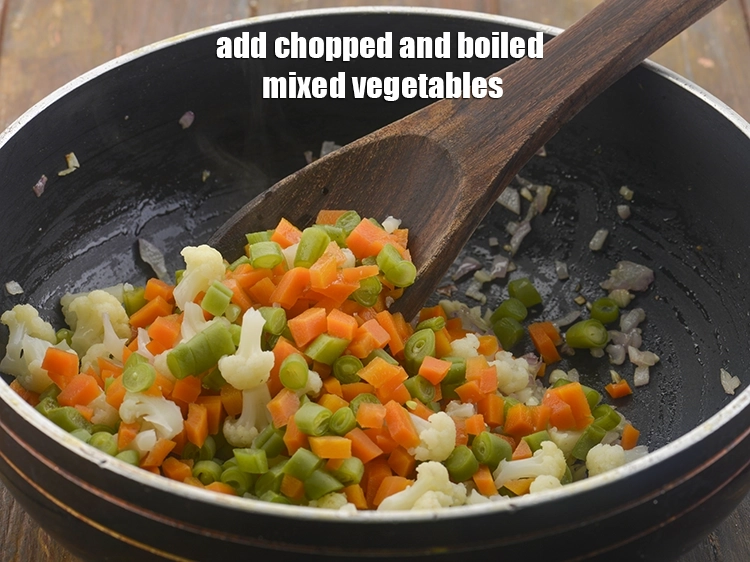 Step 6 – <p><span style="background-color:rgb(255,255,255);color:rgb(0,0,0);">Now, add the 1 cup </span><a href="https://www.tarladalal.com/glossary-mixed-vegetables-mixed-sabzi-723i#ing_2543"><u>chopped and boiled mixed vegetables</u></a><span style="background-color:rgb(255,255,255);color:rgb(0,0,0);"> into the …