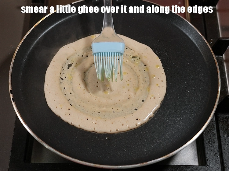 Step 17 – <p>Smear a little <a href="https://www.tarladalal.com/glossary-ghee-245i"><u>ghee</u></a> over it and along the edges. You can also use …