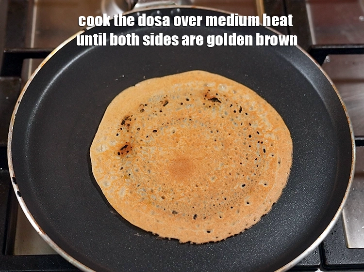 Step 18 – <p><span style="color:rgb(0,0,0);">Cook the dosa over medium heat until both sides are golden brown.</span></p>