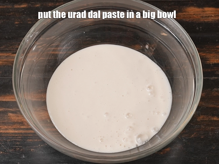 Step 8 – <p>Put the urad dal paste in a big bowl. <span style="color:rgb(0,0,0);">Urad dal, when ground into …