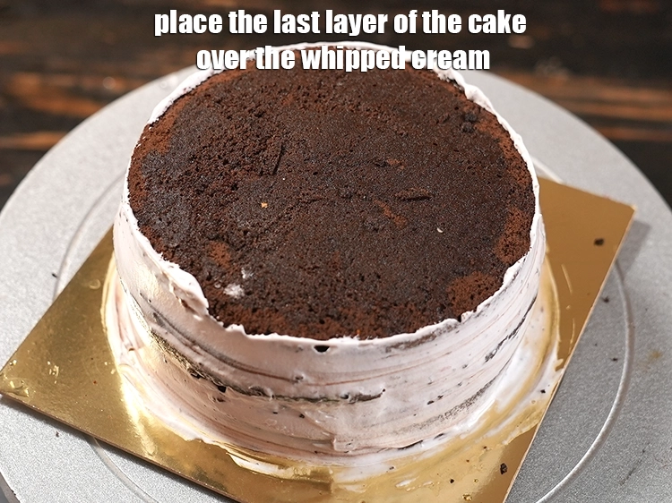 Step 27 – <p>Place the last layer of the cake over the whipped cream and press it gently.</p>