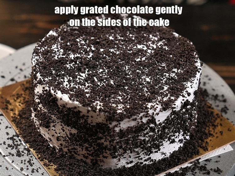 Step 33 – <p>Apply grated chocolate gently on the sides of the cake.</p>