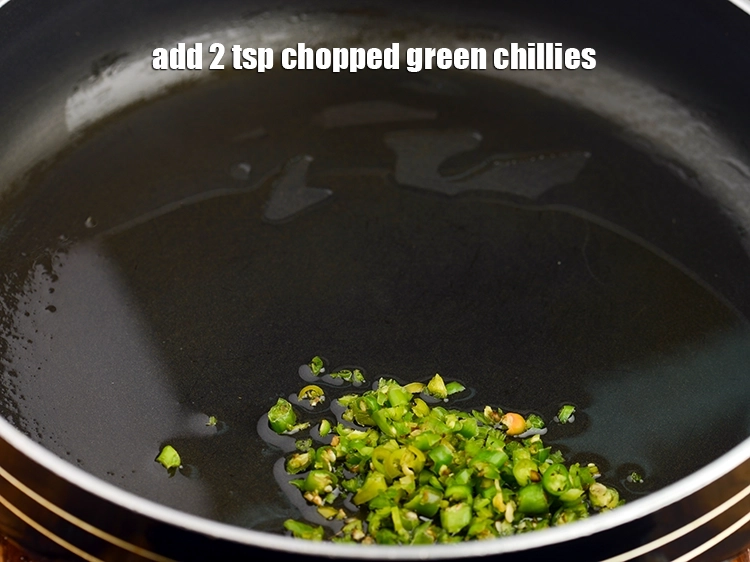 Step 11 – <p>Once the oil is hot, add the <span style="background-color:rgb(255,255,255);color:rgb(0,0,0);">2 tsp </span><a href="https://www.tarladalal.com/glossary-green-chillies-hari-mirch-331i#ing_2388"><u>chopped green chillies</u></a>. We …