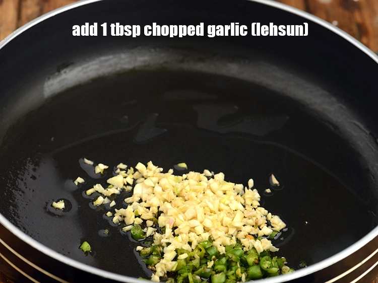 Step 12 – <p>Add <span style="background-color:rgb(255,255,255);color:rgb(0,0,0);">1 tbsp </span><a href="https://www.tarladalal.com/glossary-garlic-lehsun-lahsun-348i#ing_2370"><u>chopped garlic (lehsun)</u></a>.</p>