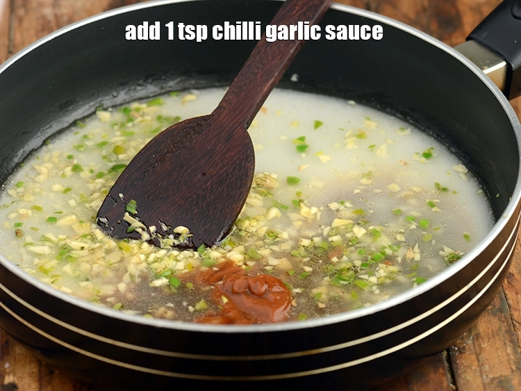 Step 17 – <p>Add <span style="background-color:rgb(255,255,255);color:rgb(0,0,0);">1 tsp </span><a href="https://www.tarladalal.com/glossary-chilli-garlic-sauce-1005i"><u>chilli garlic sauce</u></a>. You can increase or decrease the amount …