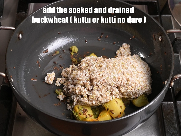 Step 18 – <p><span style="background-color:rgb(255,255,255);color:rgb(0,0,0);">Then add the soaked and drained </span><a href="https://www.tarladalal.com/glossary-buckwheat-kuttu-kutti-no-daro-kutto-427i"><u>buckwheat (kuttu or kutti no daro)</u></a><span style="background-color:rgb(255,255,255);color:rgb(0,0,0);">.</span></p>