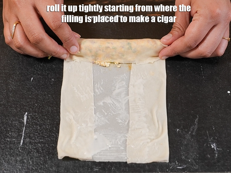 Step 22 – <p>Roll it up tightly starting from where the filling is placed to make a cigar.</p>