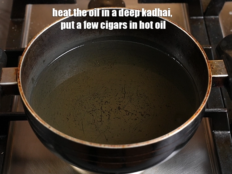 Step 24 – <p>Heat the oil in a deep kadhai, put a few cigars in hot oil.</p>