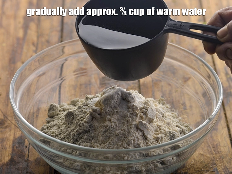 Step 20 – <html><head><meta charset="UTF-8"></head><body><p>Gradually add approx. ¾ cup of warm water. Warm water helps gluten-free bajra flour …