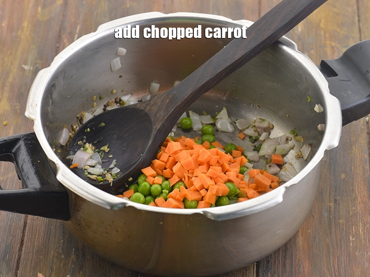Step 20 – <p><span style="background-color:rgb(255,255,255);color:rgb(0,0,0);">Now, add the 1/4 cup </span><a href="https://www.tarladalal.com/glossary-carrot-gajar-gajjar-253i#ing_2376"><u>chopped carrot</u></a><span style="background-color:rgb(255,255,255);color:rgb(0,0,0);"> to the pressure cooker as …