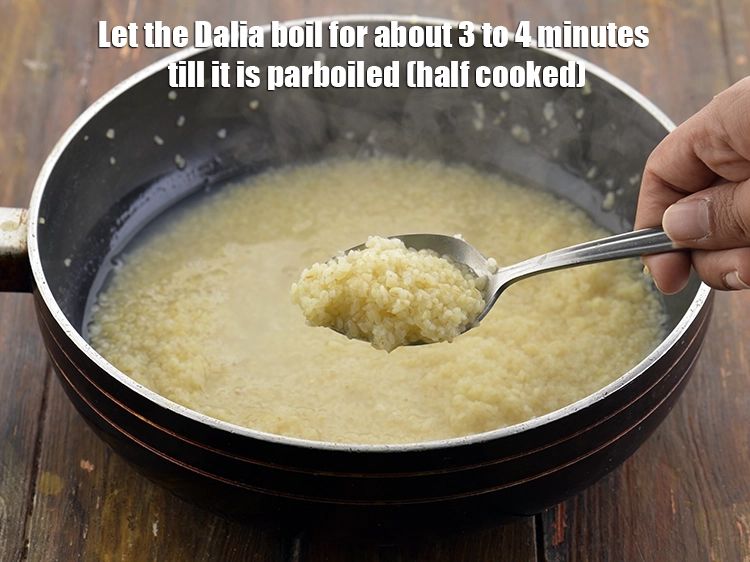 Step 7 – <p><span style="background-color:rgb(255,255,255);color:rgb(0,0,0);">Let the Dalia boil for about 3 to 4 minutes till it is parboiled …