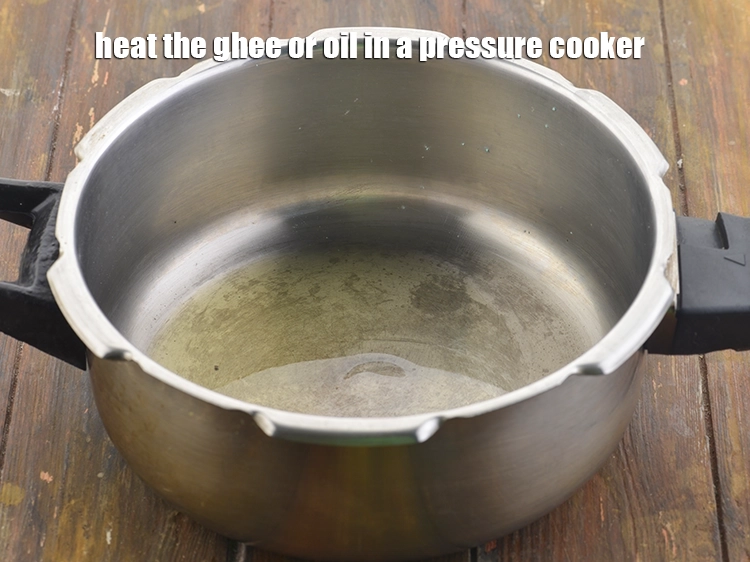 Step 9 – <p><span style="background-color:rgb(255,255,255);color:rgb(0,0,0);">Heat the ghee or 2 tsp </span><a href="https://www.tarladalal.com/glossary-oil-671i"><u>oil</u></a><span style="background-color:rgb(255,255,255);color:rgb(0,0,0);"> in a pressure cooker.</span></p>
