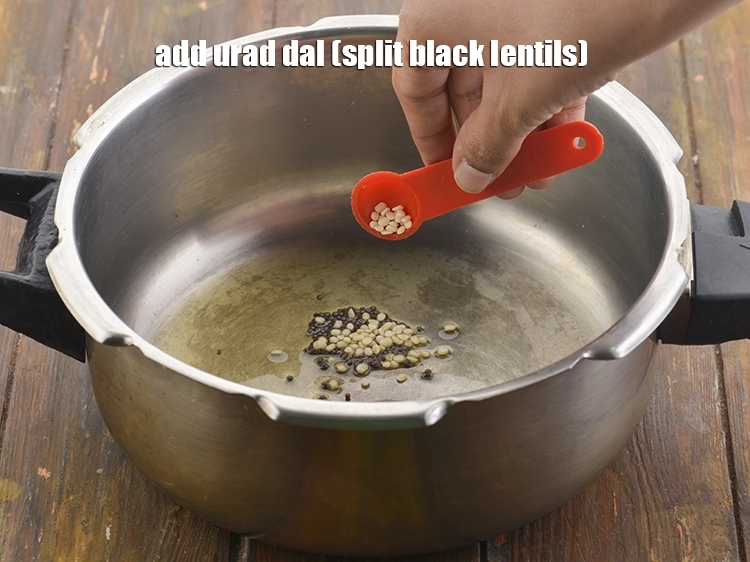 Step 11 – <p><span style="background-color:rgb(255,255,255);color:rgb(0,0,0);">When the seeds crackle, add the 1/2 tsp </span><a href="https://www.tarladalal.com/glossary-urad-dal-split-black-lentil-941i"><u>urad dal (split black lentils)</u></a><span …