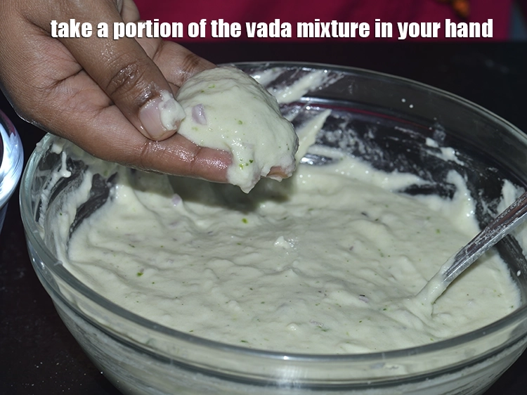 Step 23 – <p>Take a portion of the <strong>medu vada</strong> mixture in your hand.</p>