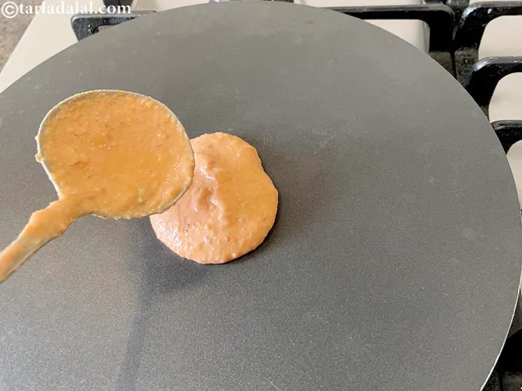 Step 27 – <p>Pour a ladleful of the South Indian mixed lentil <strong>dosa batter</strong> on it.</p>
