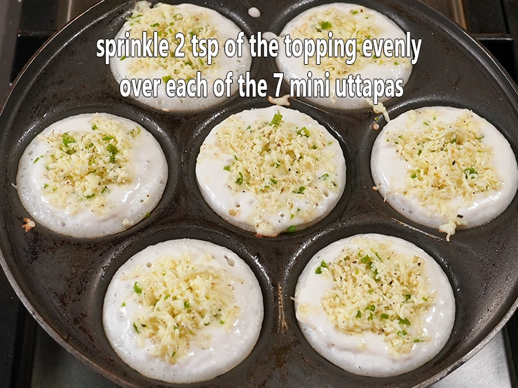 Step 7 – <p>Sprinkle 2 tsp of the topping evenly over each of the 7 mini uttapas.&nbsp; For …
