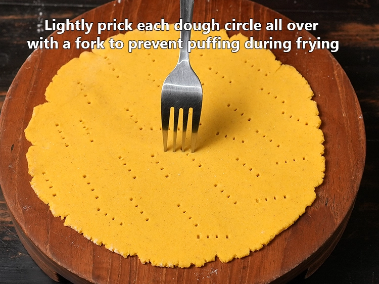 Step 10 – <p>Lightly <strong>prick each dough circle all over with a fork</strong> to prevent puffing during frying.</p><p><br>&nbsp;</p>