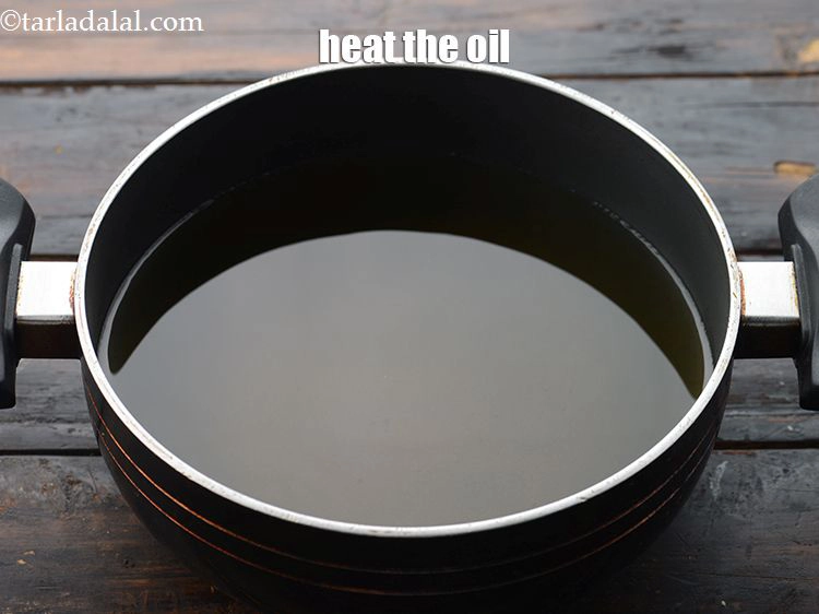 Step 7 – <p>To fry bateta chips, heat the <a href="https://www.tarladalal.com/glossary-oil-671i">oil</a>&nbsp;in a deep non-stick kadhai.</p>