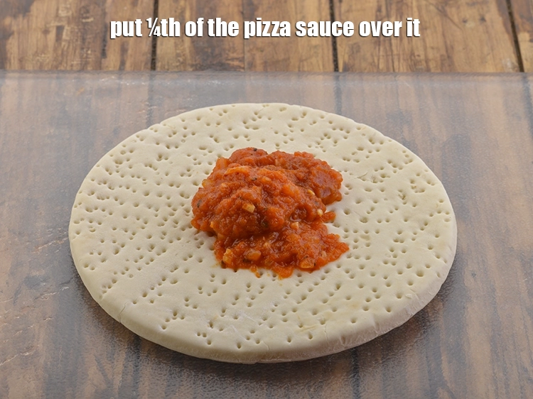 Step 24 – <p>Put ¼th of the pizza sauce over it.</p>