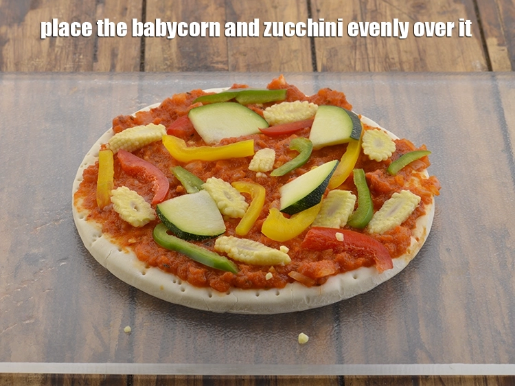 Step 27 – <p>Place the babycorn and zucchini evenly over it. Always spread the veggies evenly so that …
