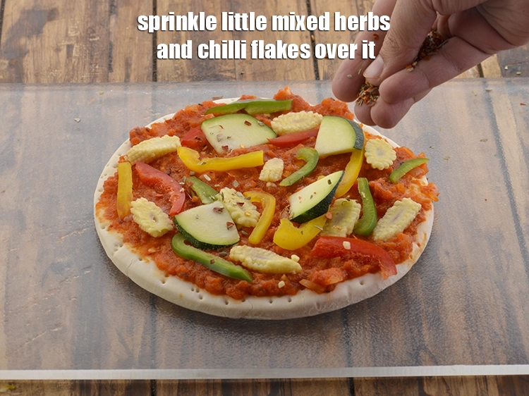Step 28 – <p>Sprinkle little mixed herbs and chilli flakes over it. If you do not have mixed …