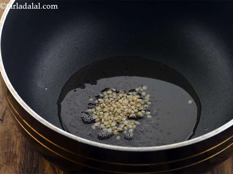 Step 20 – <p><span style="color:rgb(0,0,0);">When the seeds crackle, add the urad dal.</span></p>