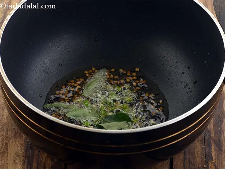 Step 23 – <p>Add the <span style="background-color:rgb(255,255,255);color:rgb(0,0,0);">7 to 8 </span><a href="https://www.tarladalal.com/glossary-curry-leaves-kadi-patta-kadipatta-388i"><u>curry leaves (kadi patta)</u></a>.</p>