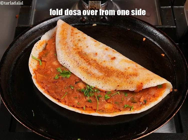 Step 58 – <p>Fold&nbsp;<strong>Mumbai street style</strong>&nbsp;<strong>Mysore masala dosa</strong>&nbsp;over from one side.</p>