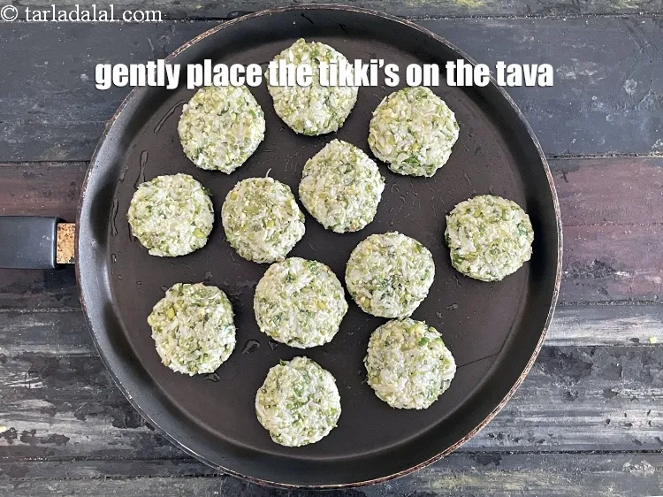 Step 16 – <html><head><meta charset="UTF-8"> </head><body><p>Place the 12&nbsp;tikkis carefully over it.&nbsp;&nbsp;&nbsp;</p></body></html>