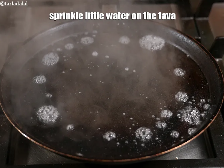 Step 49 – <p>Sprinkle little water on the tava, it should sizzle immediately.&nbsp; If the water is not …