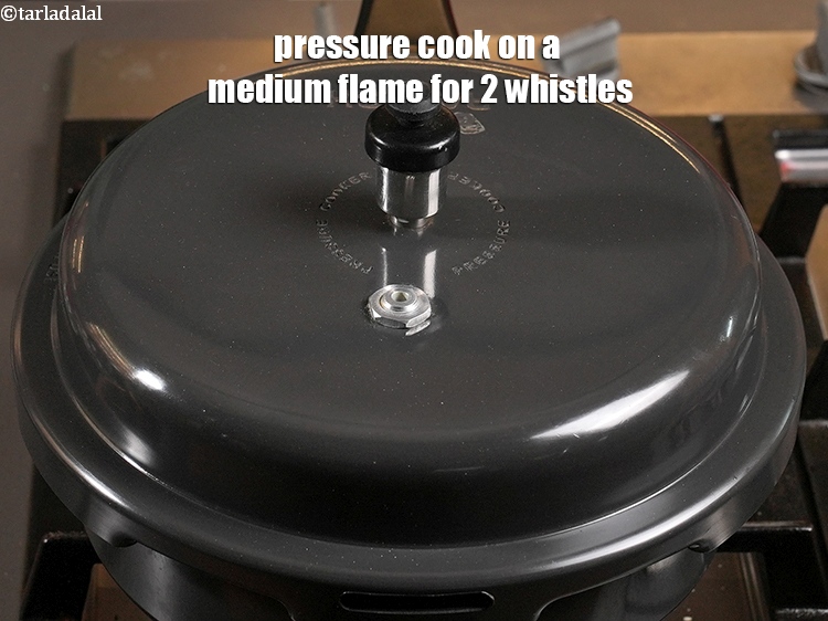 Step 51 – <p>Pressure cook on a medium flame for 2 whistles.&nbsp;</p>