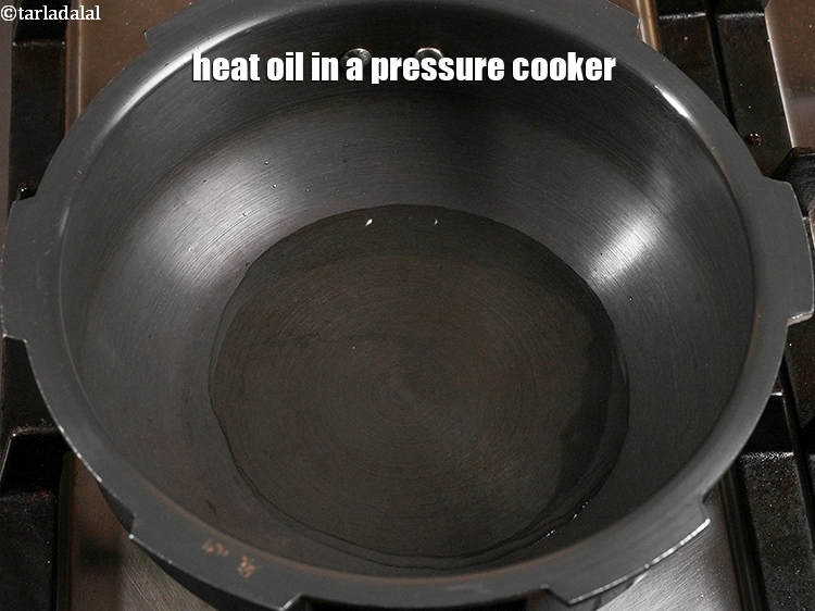 Step 22 – <p>Heat 1 tbsp <a href="https://www.tarladalal.com/glossary-oil-671i">oil</a> in a pressure cooker.</p>