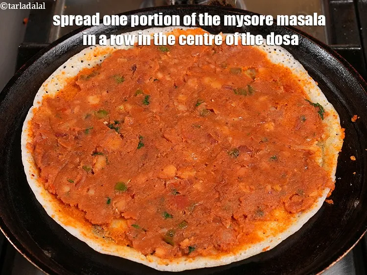 Step 57 – <p>Spread one portion of the mysore masala in a row in the centre of the …