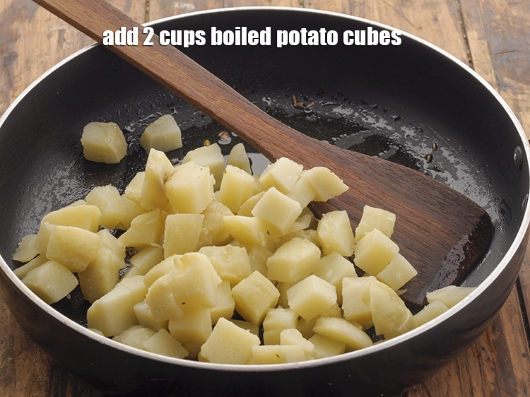 Step 15 – <p>Add all the remaining ingredients, starting with <span style="background-color:rgb(255,255,255);color:rgb(0,0,0);">2 cups </span><a href="https://www.tarladalal.com/glossary-potatoes-aloo-alu-batata-710i#ing_2605"><u>boiled potato cubes</u></a>.</p>