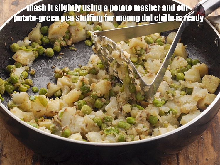 Step 21 – <p>Mash it slightly using a potato masher and our potato-green pea stuffing for moong dal …
