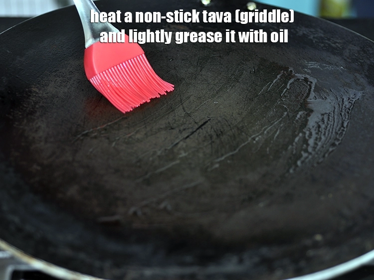 Step 22 – <p>To prepare <strong>stuffed moong dal cheelas</strong>, heat a non-stick tava (griddle) and lightly grease it …