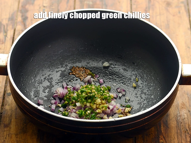 Step 16 – <p><span style="background-color:rgb(255,255,255);color:rgb(0,0,0);">Add 2 tsp finely </span><a href="https://www.tarladalal.com/glossary-green-chillies-hari-mirch-331i#ing_2388"><u>chopped green chillies</u></a><u>.</u></p>