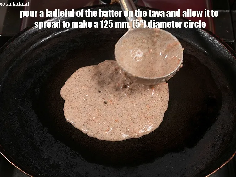 Step 12 – <p>Pour a ladleful of the batter on the tava (griddle) and allow it to spread …