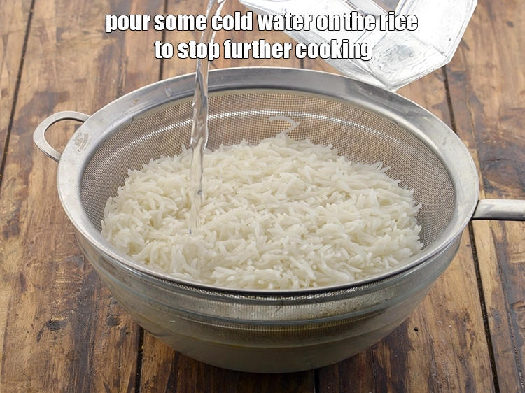 Step 10 – <p>Pour some cold water on the rice to stop further cooking.&nbsp;Let all the water from …
