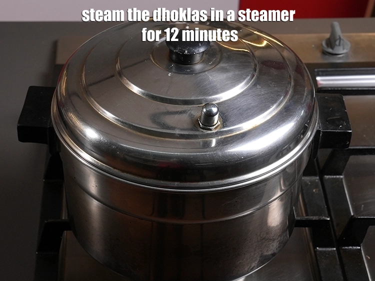 Step 21 – <p>Steam the dhoklas in a steamer for 12 minutes or till the dhoklas are cooked.</p>