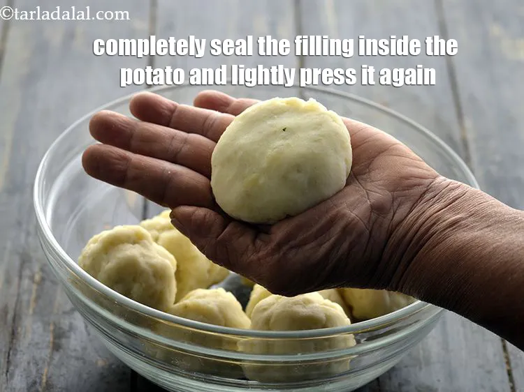 Step 41 – <p>Completely seal the filling inside the potato and lightly press it again in between the …